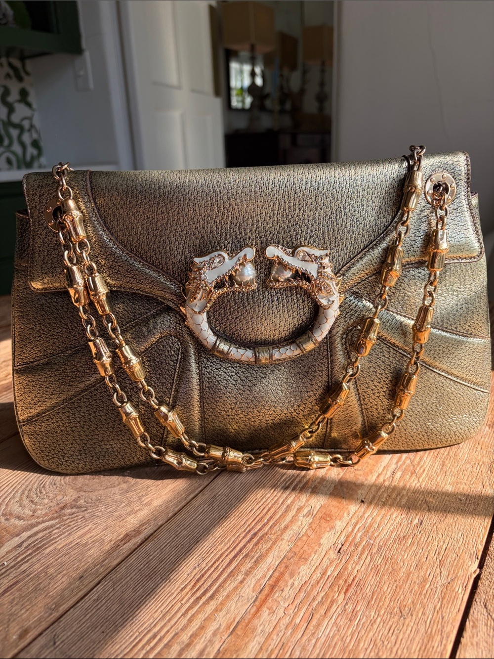 Gucci Metallic Gold Shoulder Bag with Decorative Double Dragon Jeweled clasp.